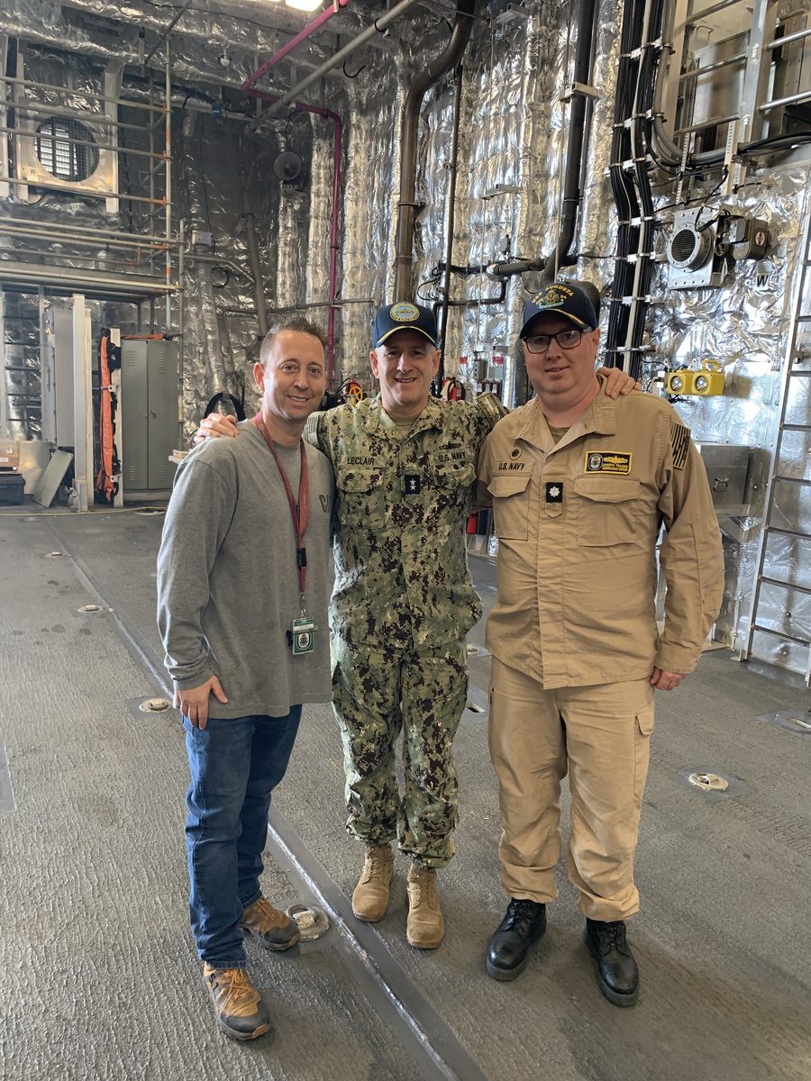 IMS field-service team with Theodore LeClair in uniform aboard ship